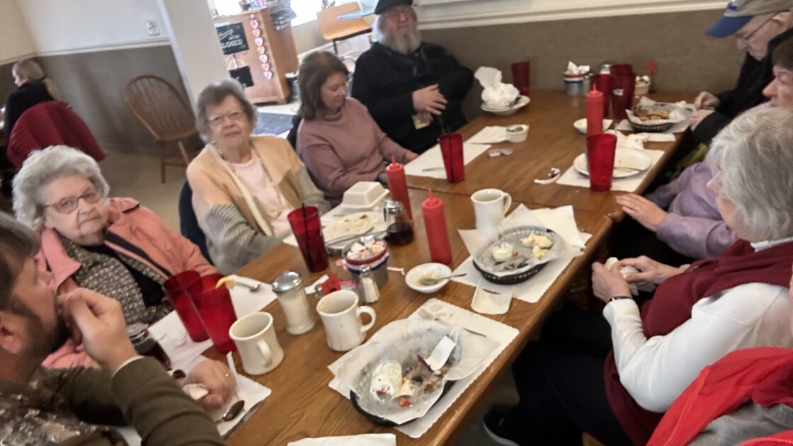 Members sharing a meal at a local restaurant